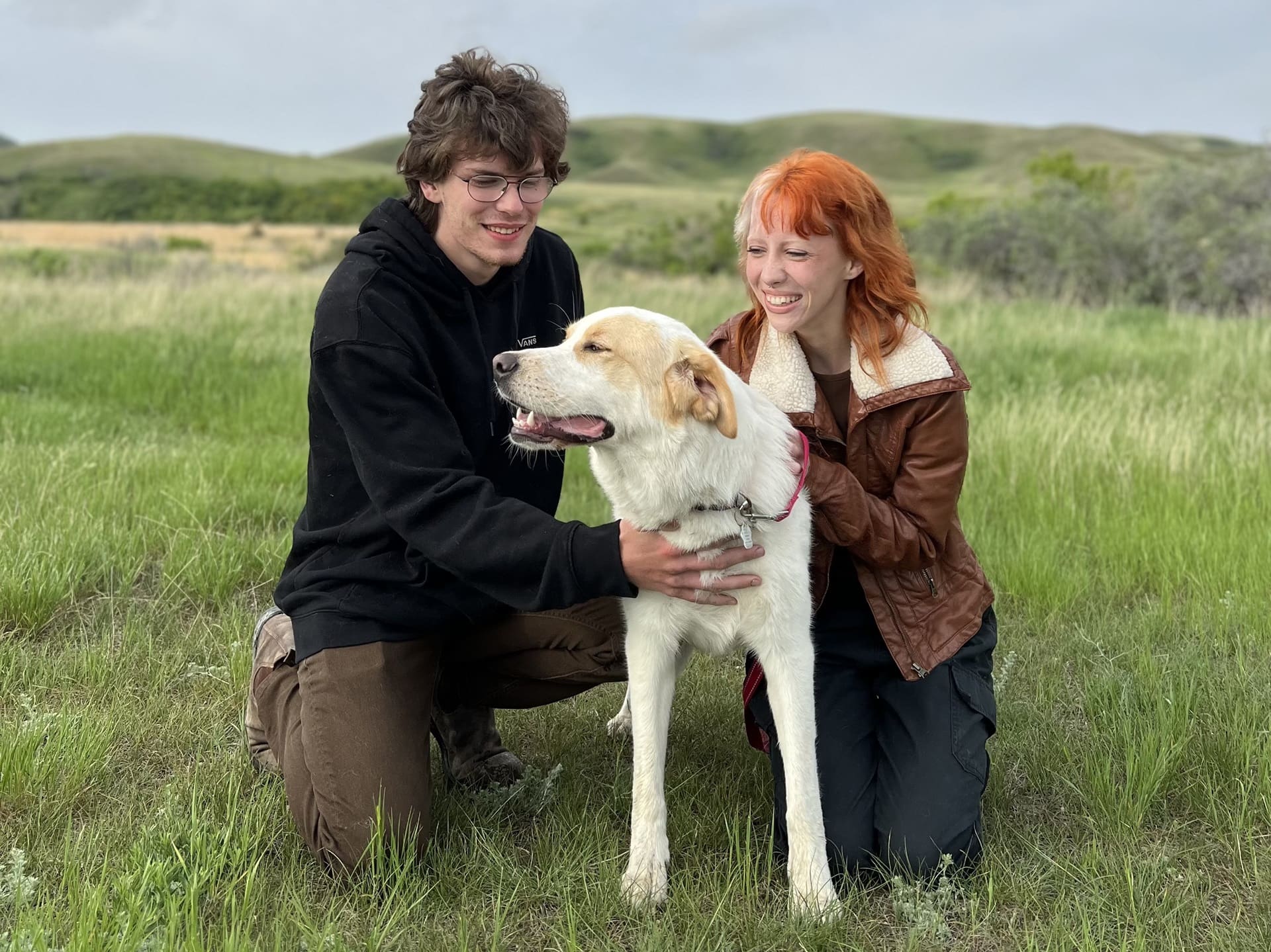 man and woman with their foster dog